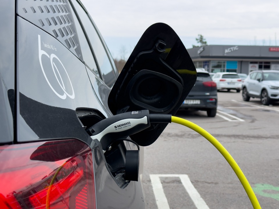 An EV charging cable plugged into a car